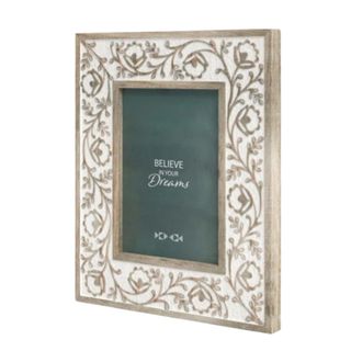 A white and brown floral and vine patterned photo frame