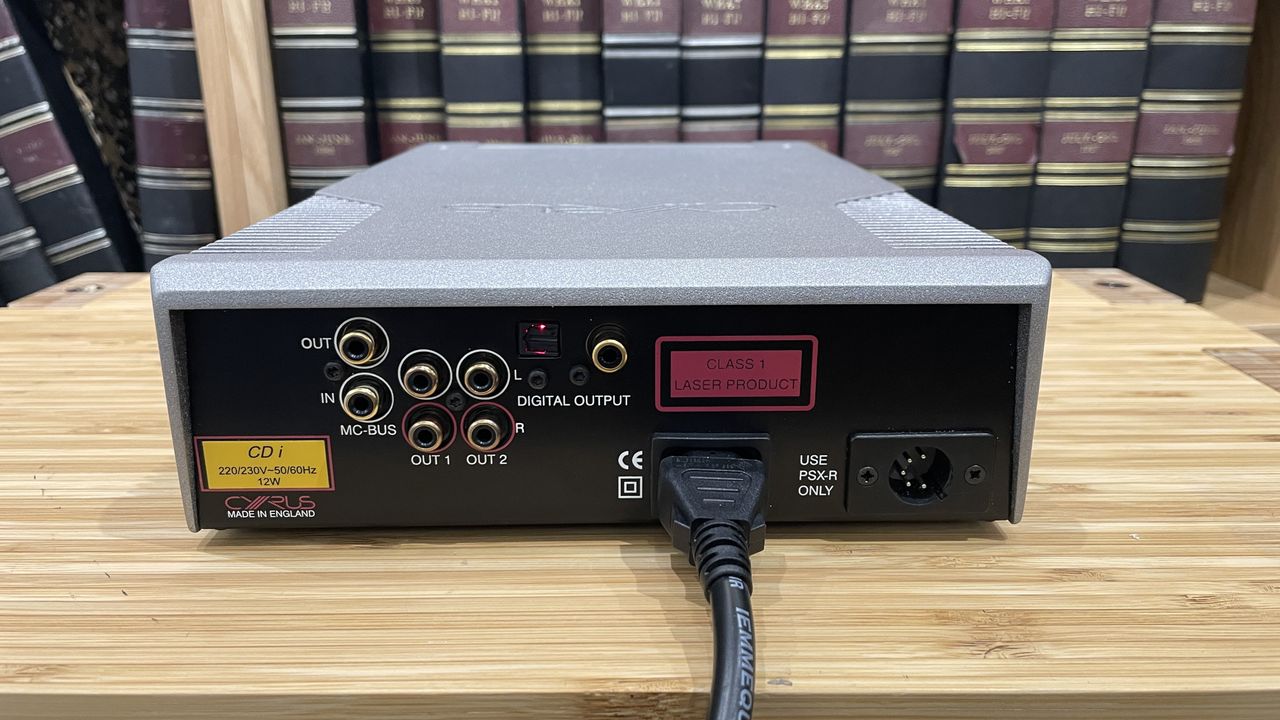Cyrus CDi player on wooden rack with magazines in background