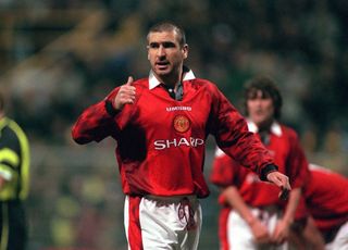 Eric Cantona gives a thumbs-up gesture during a Champions League game for Manchester United against Borussia Dortmund in 1997.