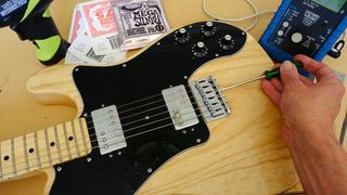 Adjusting intonation on an electric guitar