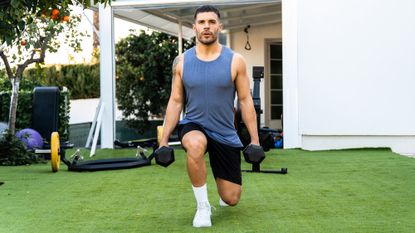 Man performing dumbbell lunges