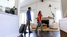Couple with suitcase in a holiday home