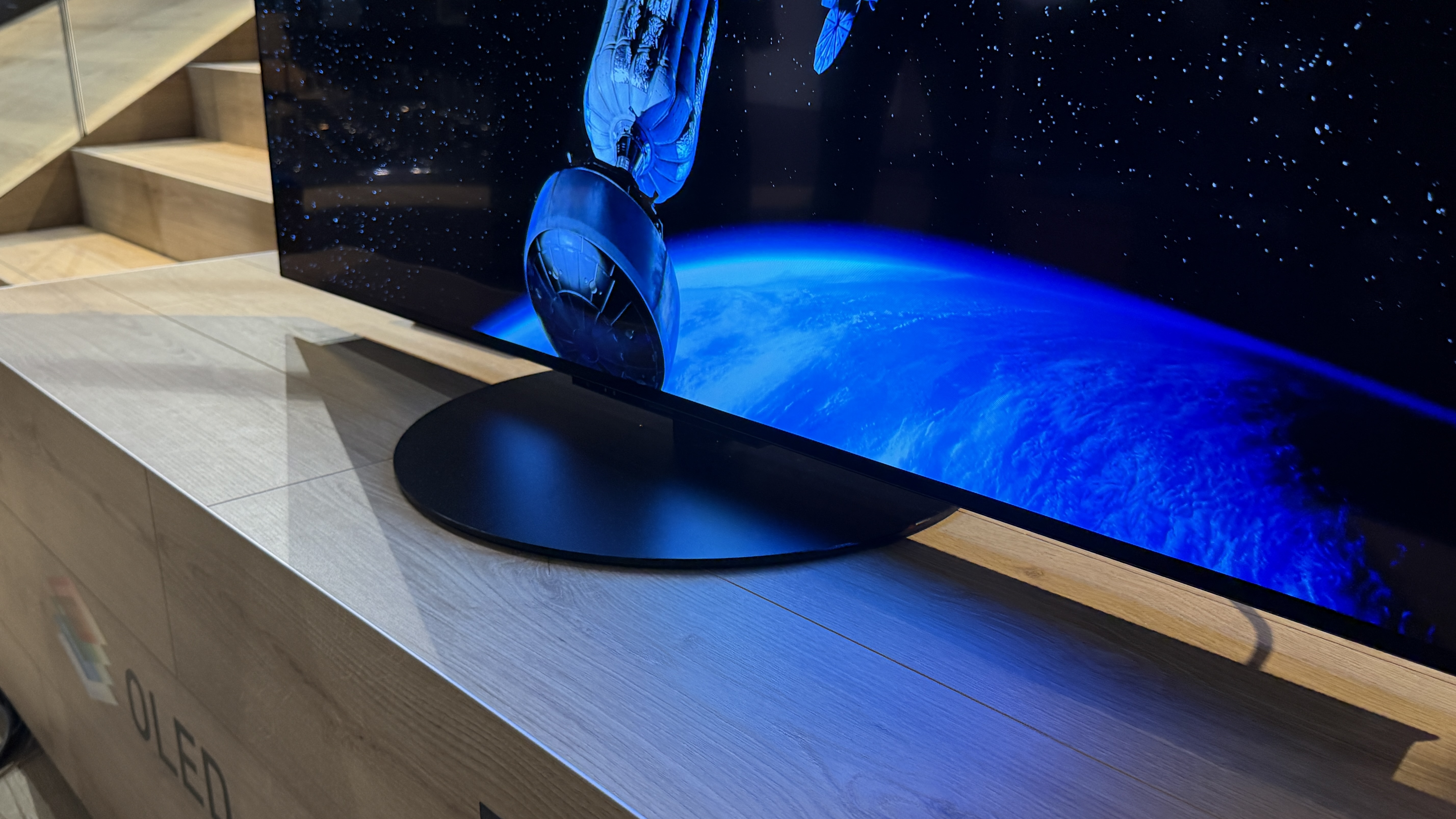 Panasonic Z85C with sci-fi images on screen sitting on a wooden tabletop