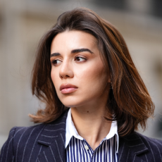 Best concealers for dry skin - Katie Degas wears a blue and white striped shirt, a blazer jacket, during a street style fashion photo session, on May 07, 2025 in Paris, France.
