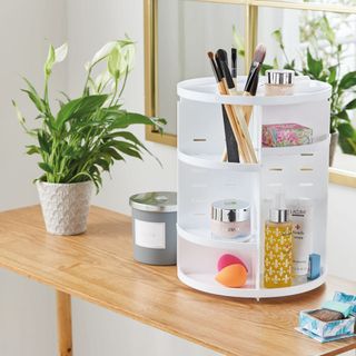 white coloured makeup storage tower on wooden table