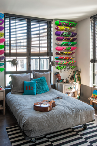 teenage boy bedroom with skate boards on the wall