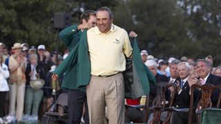 Angel Cabrera receives the Green Jacket from Trevor Immelman after winning the 2009 Masters