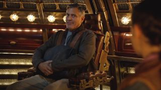 George Clooney sits tight with a look of disbelief in Tomorrowland.