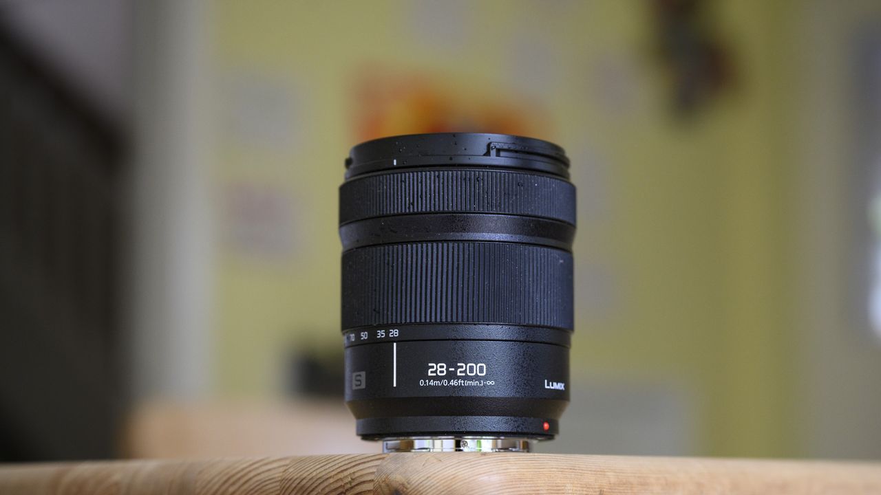 Panasonic Lumix S 28-200mm travel lens on a wooden table, retracted