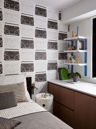 A black and white kid's room with lots of pattern on bed and wall