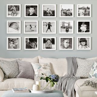 photo gallery in room with sofa set with cushion and flower in vase with books