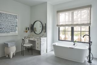 white bathroom with marble makeup counter by Michelle Gerson