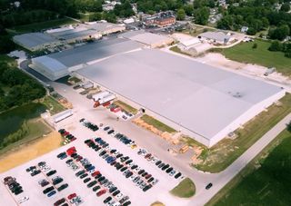 An aerial view of the new Draper facilities and parking lot with multiple vehicles.