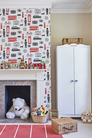 Children's bedroom with london themed wallpaper over fireplace