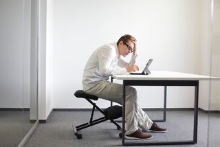 Sitting hunched over your computer can lead to pain over time.