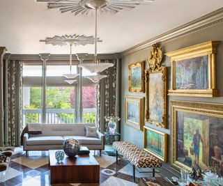 living room with marble floor and taupe walls with gallery wall of paintings