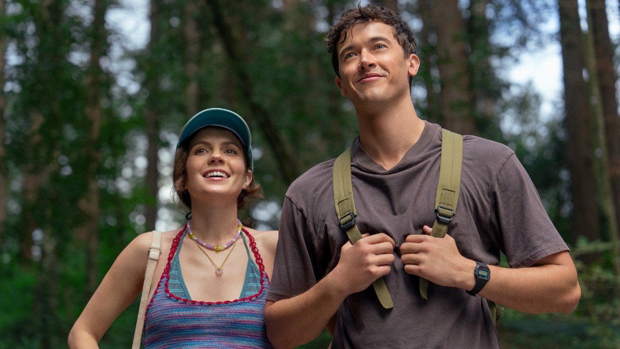 Alex and Poppy standing and smiling while looking up.