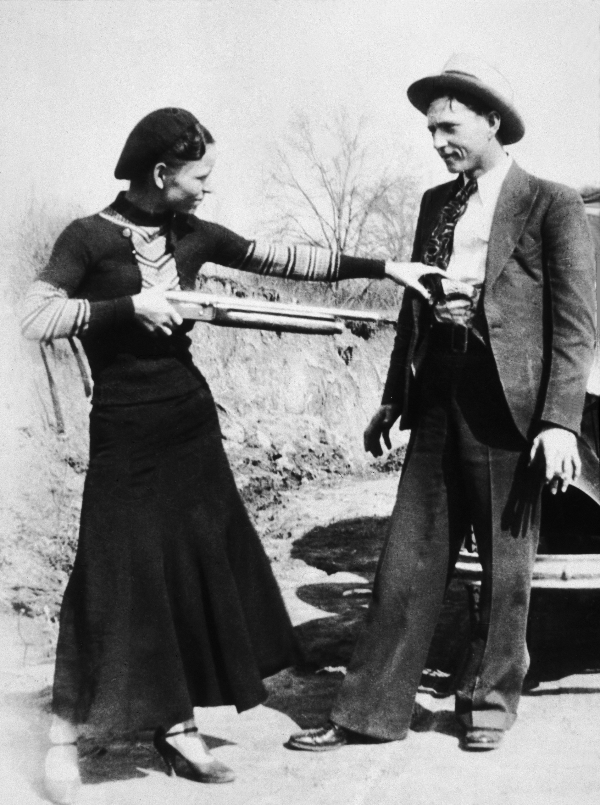 Circa 1932, USA, Bonnie Parker points a shotgun at boyfriend Clyde Barrow, together they found infamy as ,Bonnie and Clyde from August 1932 until they were killed at a Police roadblock by Police in May 1934,