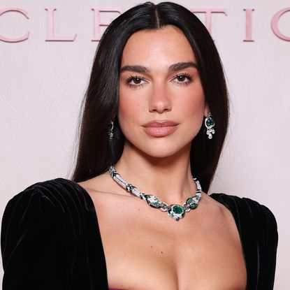 Dua Lipa attended a Bulgari event in Milan dressed in a peekaboo bra dress from Balmain