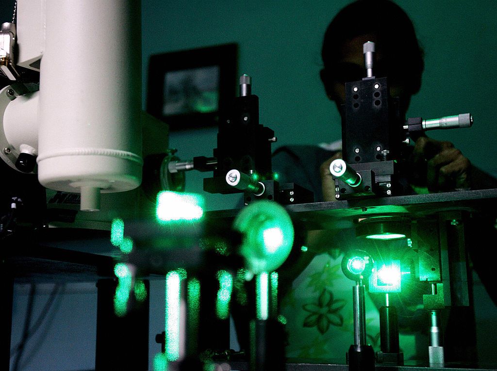 Research scholar experiments with lasers.