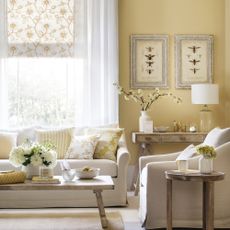 Yellow living room with floral patterned blinds and light curtains