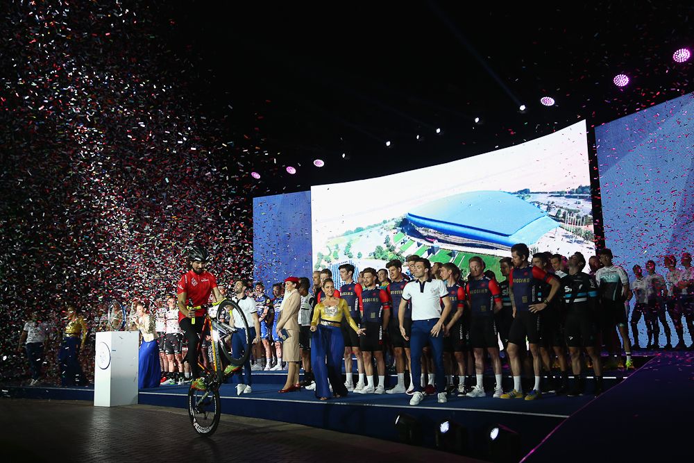 A cyclist performs in front of the teams during the team presentation show at the Westin hotel