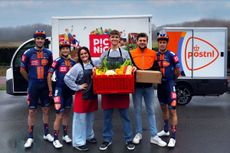 Four Picnic PostNL riders in their new navy kit with members of Picnic and PostNL staff