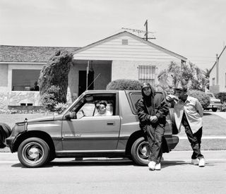 Men leaning on car, from pages of Rapper's Deluxe
