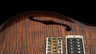 A detail photo of the PRS SE Custom 24 Semi-Hollow Piezo in Orange Tiger Smokeburst finish