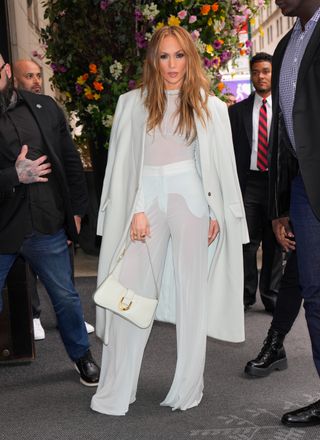Jennifer Lopez wearing a sheer mint green ensemble and Charles & Keith's Gabine handbag while heading to 'Atlas' NYC premiere May 2024