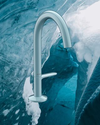 blue tap against icy, watery background