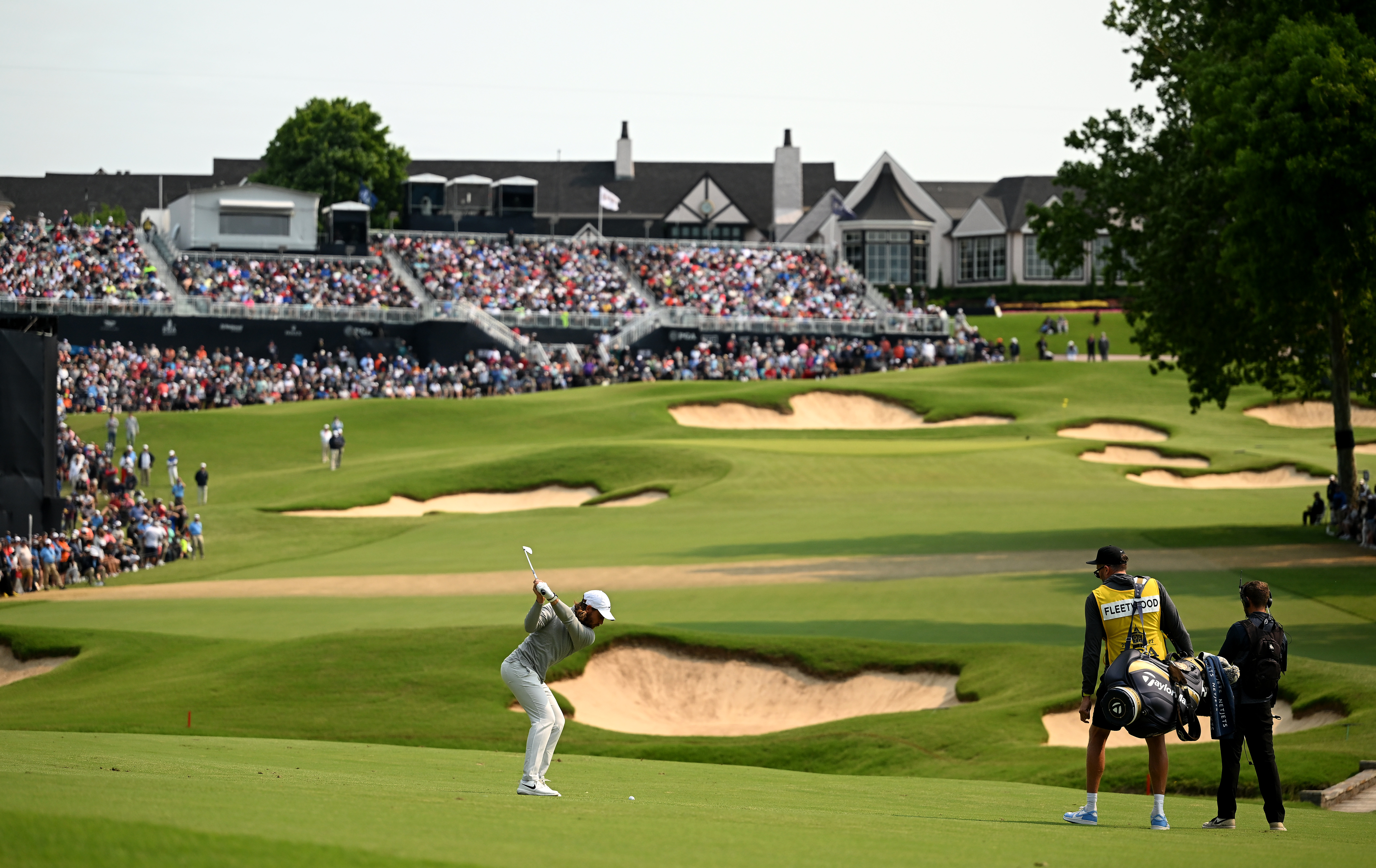 Tommy Fleetwood hits an iron shot into the final hole at Southern Hills