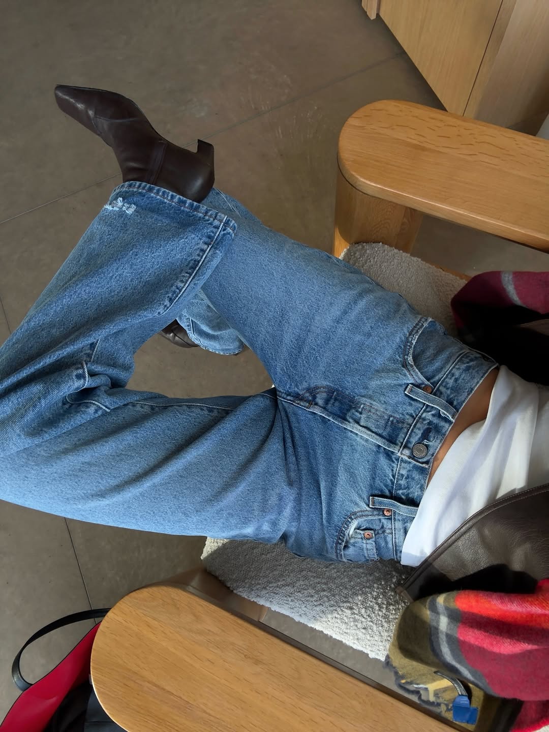 A woman wearing perfect vintage wash jeans, one of the rich-looking spring denim trends 2026.