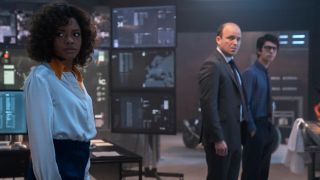 Naomie Harris looking worried in the MI6 office with Rory Kinnear and Ben Whishaw in No Time To Die.