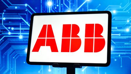 ABB logo pictured on a tablet screen with networking traffic concept image in background.
