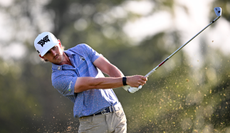 Jake Knapp hits a wedge shot from a bunker