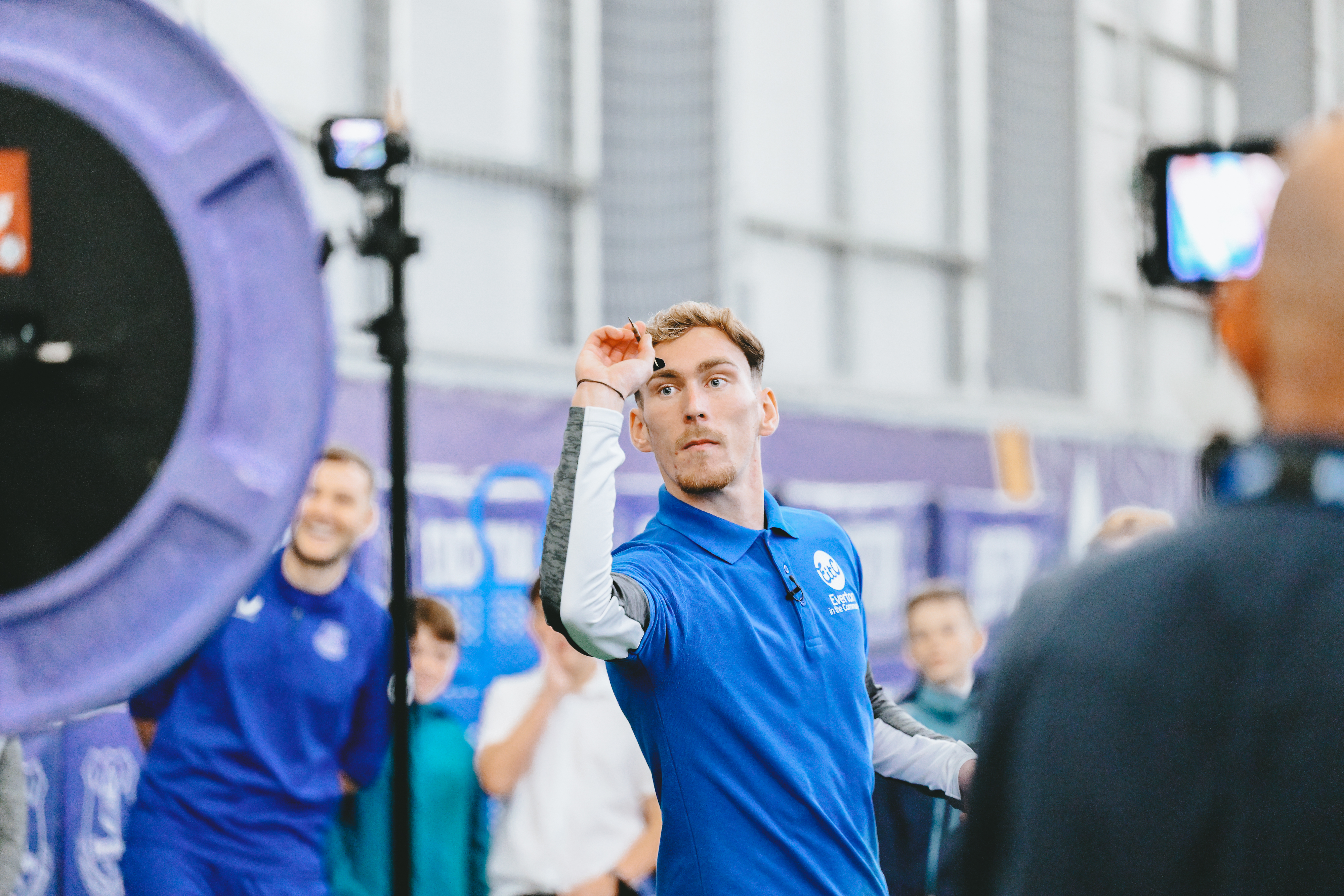 James Garner plays darts at Everton&#039;s Finch Farm Training Ground with young fans as part of an Everton In the Community event