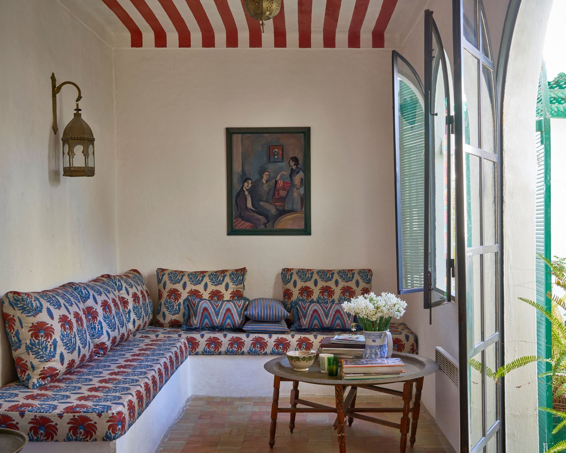 Outdoor/indoor seating area with a bench upholstered in Liberty fabric