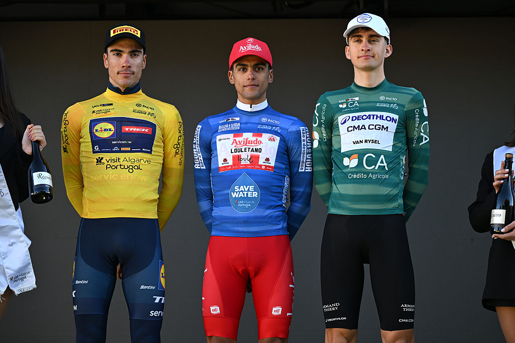VILLAMOURA, PORTUGAL - FEBRUARY 20: (L-R) Juan Ayuso of Spain and Team Lidl - Trek - Yellow Leader Jersey, Tomas Contte of Argentina and Team Aviludo - Louletano - Loule - Blue Mountain Jersey and Paul Seixas of France and Team Decathlon CMA CGM - Green Points Jersey pose on the podium ceremony after the 52nd Volta ao Algarve em Bicicleta 2026, Stage 3 a 19.5km individual time trial stage from Vilamoura to Vilamoura on February 20, 2026 in Vilamoura, Portugal. (Photo by Dario Belingheri/Getty Images)