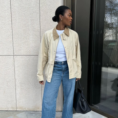 @nlmarilyn wearing a white t-shirt, barn jacket, jeans and loafers