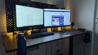 The Dezctop Bifrost Elite 160 set up, with two monitors and a keyboard.