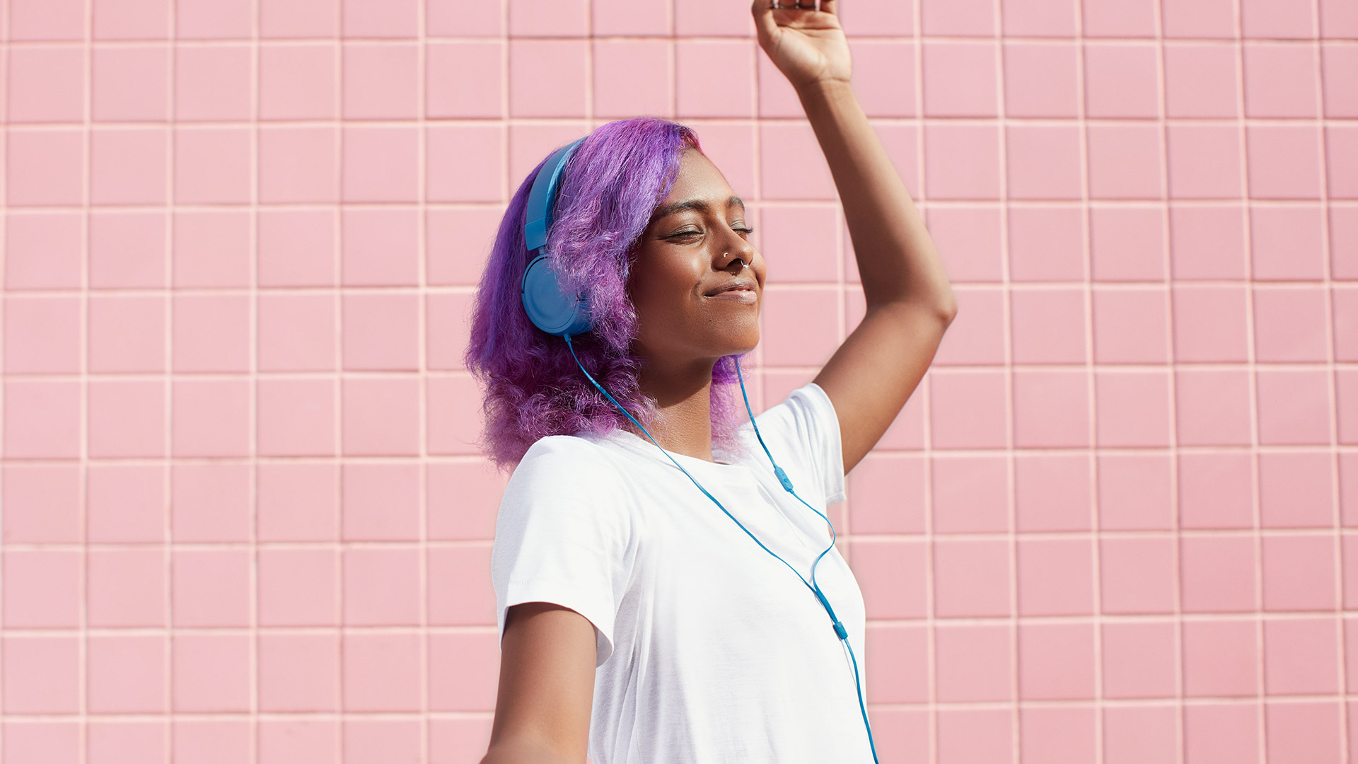 A Spotify listener dancing with headphones on