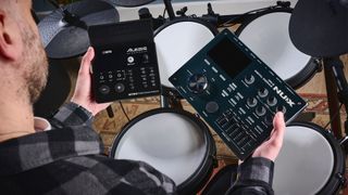 Man compares teo electronic drum modules