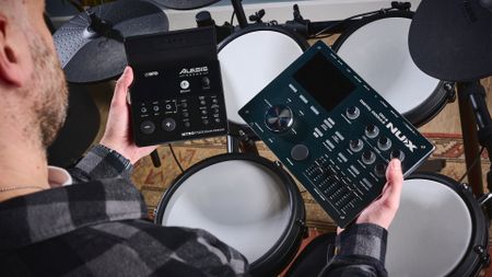 Man compares teo electronic drum modules