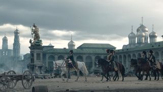 Napoleon VFX; men on horses walk past a building