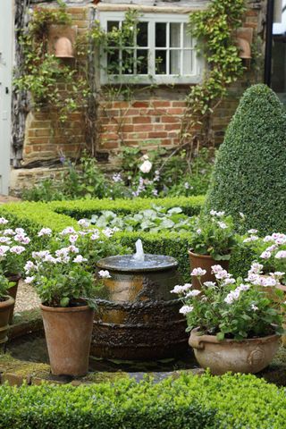 small fountain in cottage style garden