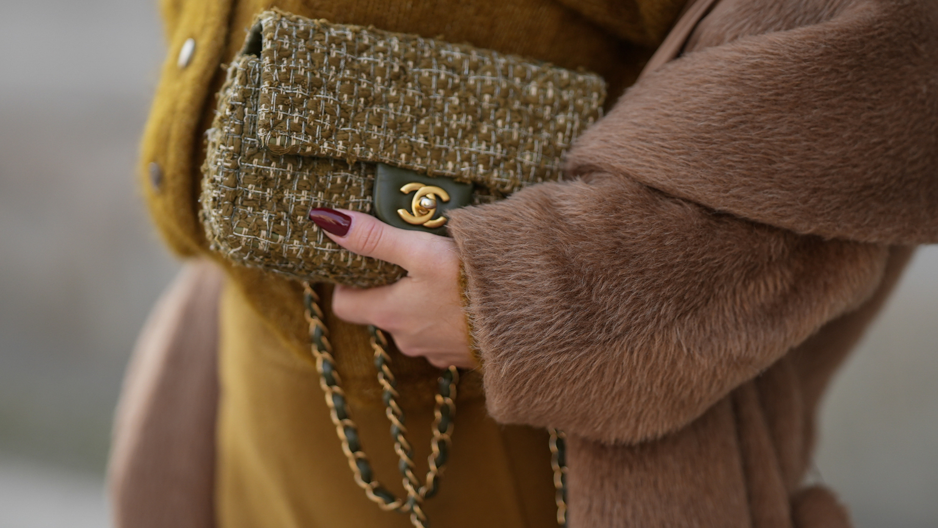 best nail shades for party season Laura Noltemeyer is seen wearing a a long camel-colored brushed wool coat with a wrap silhouette and integrated belt by Max Mara; a mustard-colored knit cardigan with a brushed cable-knit pattern and front button fastening by Sézane; a mustard yellow brownish mini skirt in a soft wool fabric by Sézane; a small quilted tweed flap bag in a khaki Color with woven fabric material with a gold chain strap and CC clasp by Chanel; her brown hair is styled in loose waves with a center part on November 13, 2025 in Hamburg, Germany