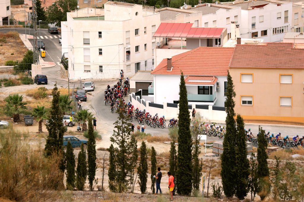 VELEFIQUE SPAIN AUGUST 22 The peloton passing through Tijola village during the 76th Tour of Spain 2021 Stage 9 a 188 km stage from Puerto Lumbreras to Alto de Velefique 1800m lavuelta LaVuelta21 on August 22 2021 in Velefique Spain Photo by Gonzalo Arroyo MorenoGetty Images