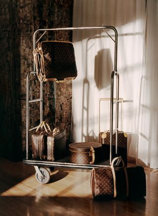 Louis Vuitton luggage set hanging from rail