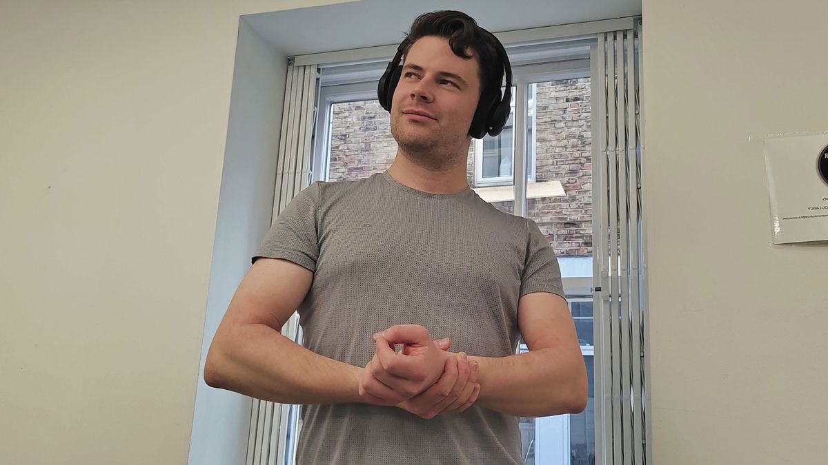 The author wearing the UA Project Rock Over-Ear Training headphones